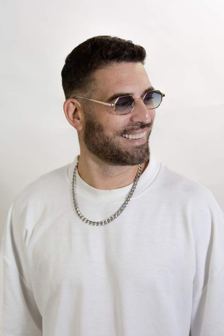 headshot of popof in sunglasses and white sweater