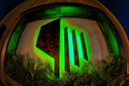 The ominous green silo sign outside of the venue uopn a brick wall