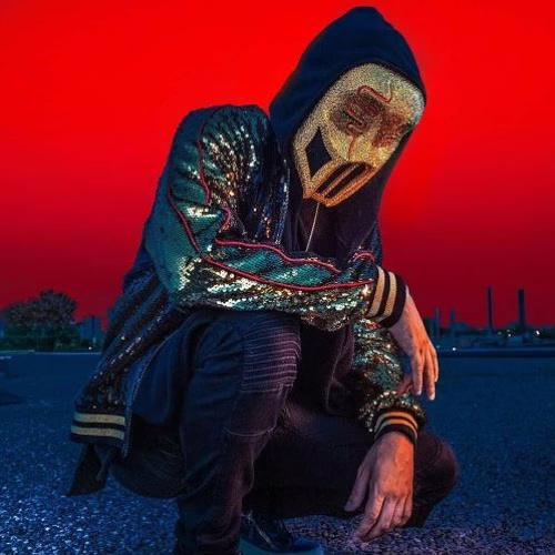 Sickick posing upon a red background with his glittery mask on