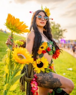 a beautiful sunflowered woman psoing benath the sun