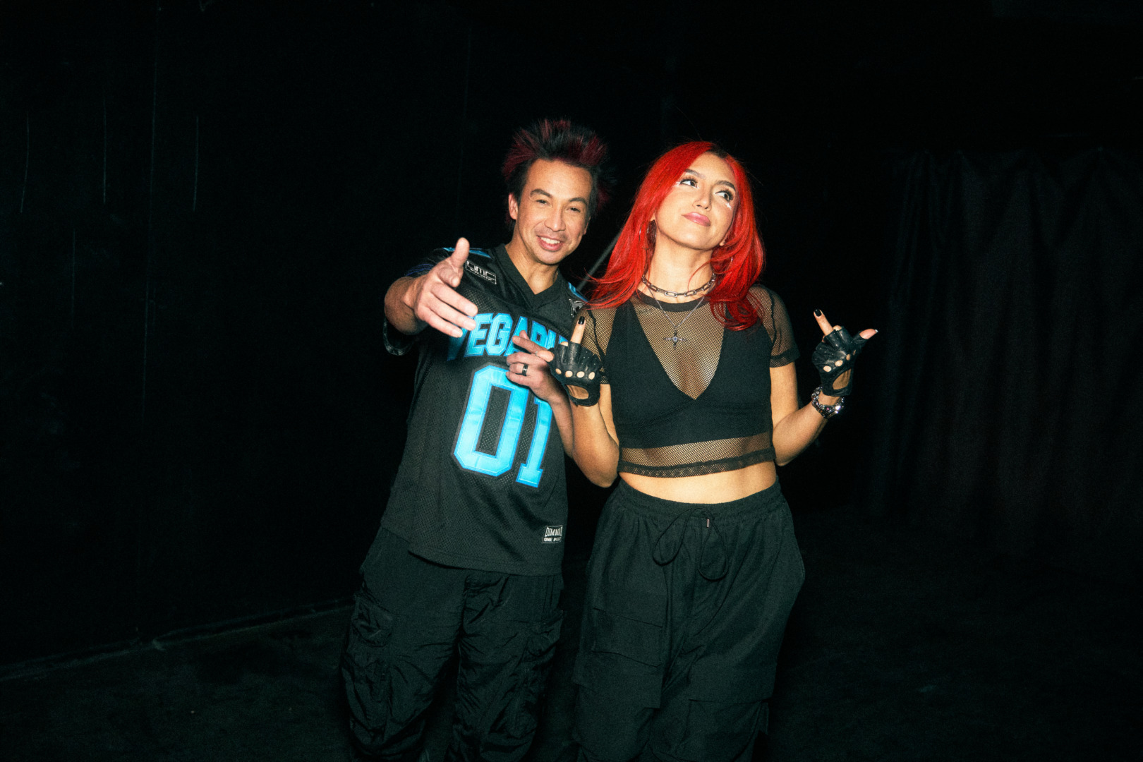 Laidback luke and nostalgix posing together in a night sky flipping off the camera