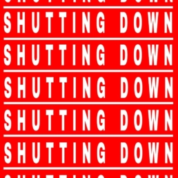 shutting down in white letters vertically across a red back ground