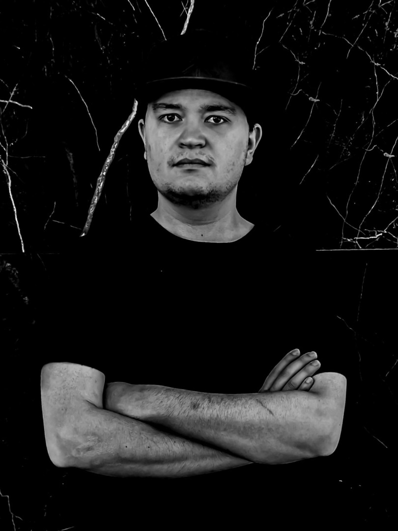 black and grey photo posing in a black shirt