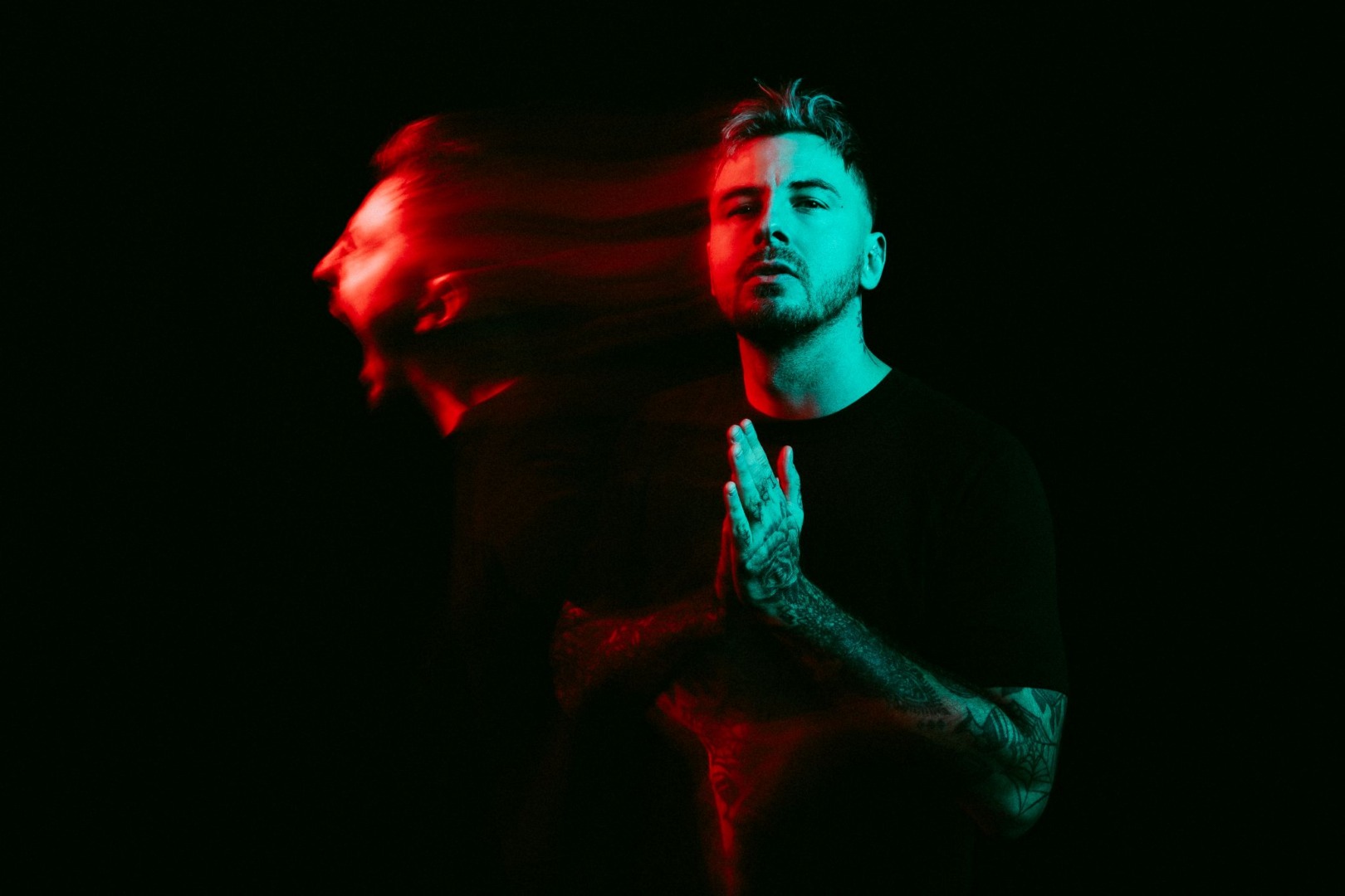Faustix posing on a dark background blurred with a blueish hue to the photograph