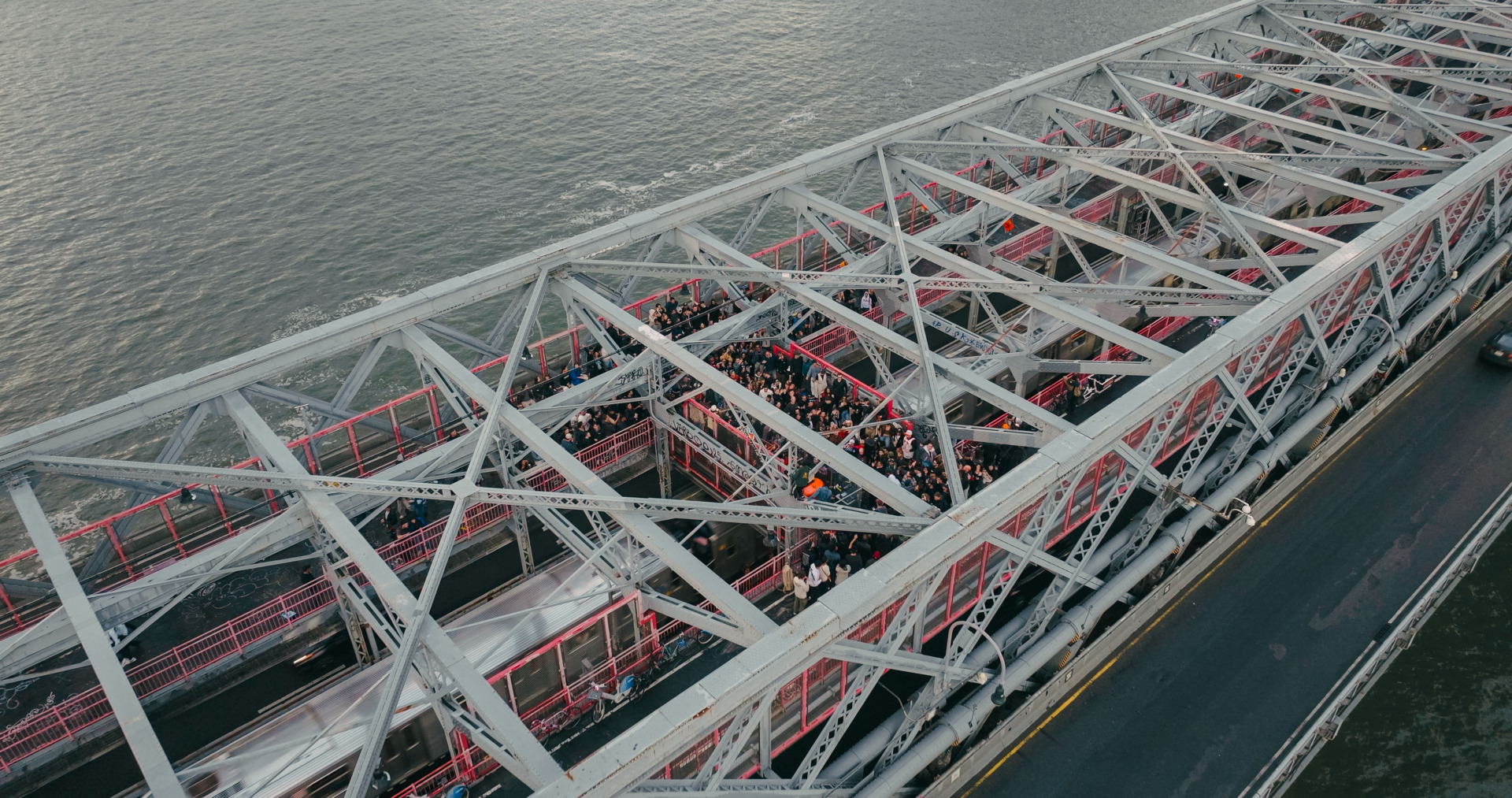 Charlotte de Witte performing to a crowd on top of the williamsbur brdige in the rain