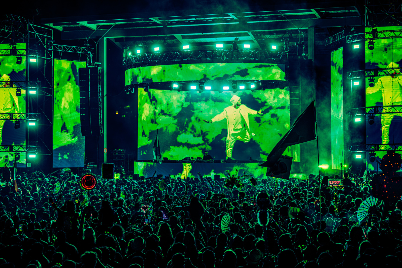 Fisher performing in a green hueish tinit