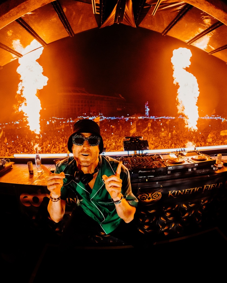 FISHER posing infront of the decks as the fire goes off behind him