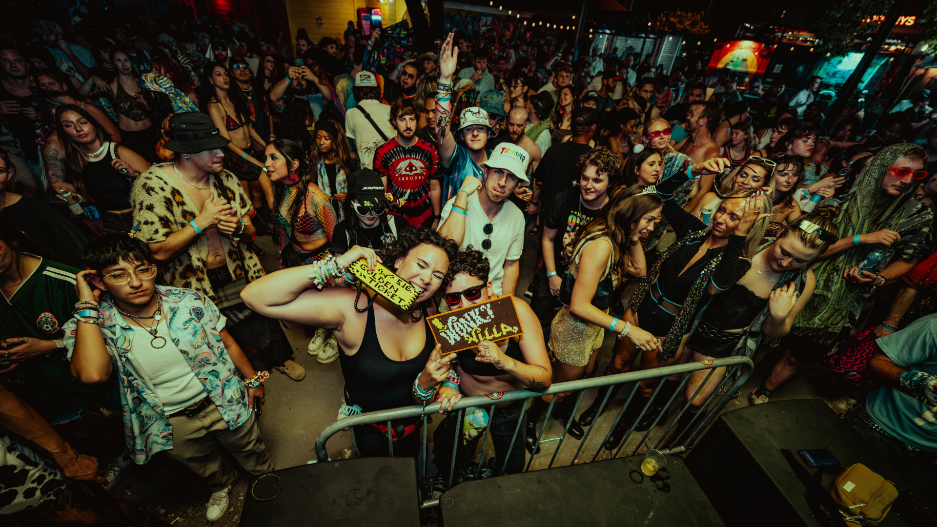 Fans standing agsint the rails holding the golden ticket