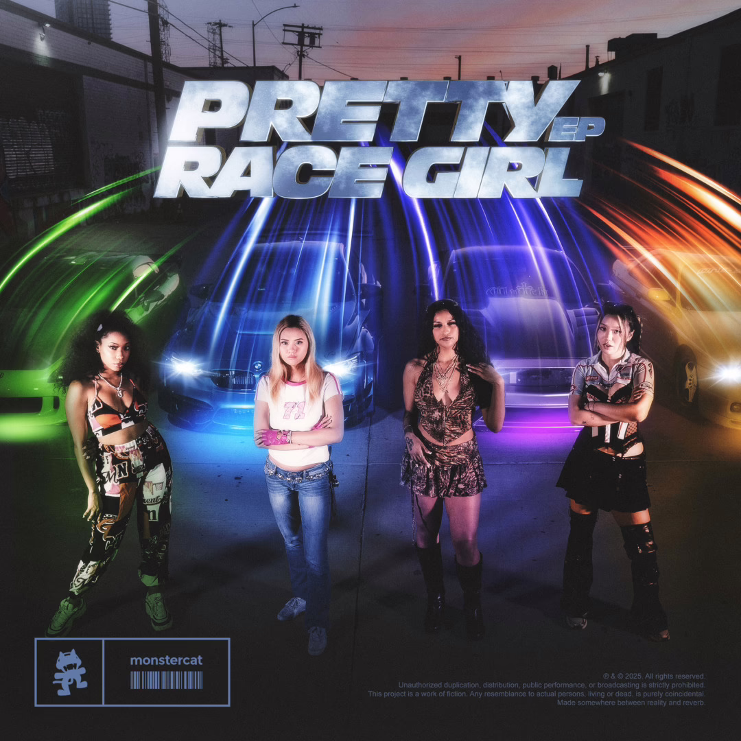 three girls standing infront of race cars