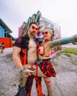 Couple standing in front of the illfest sign