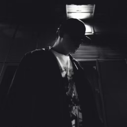 A shadowy photo of a man in the inner city scape