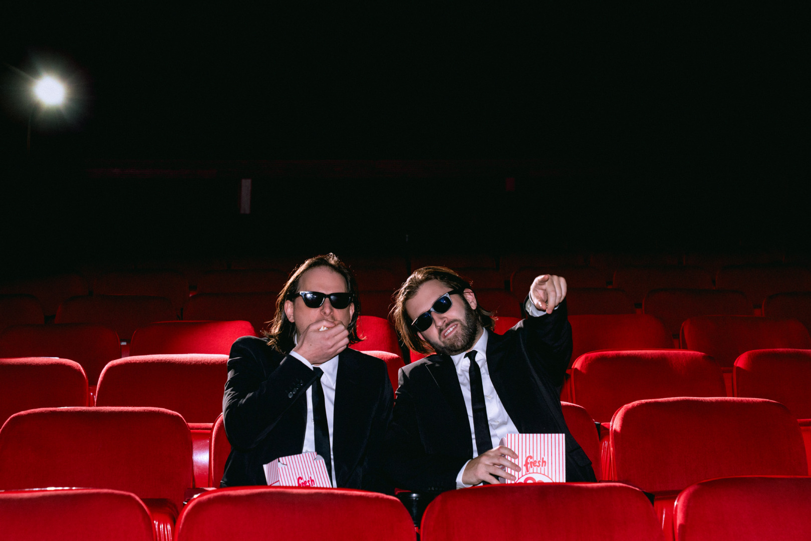 Zeds Dead eating pop corn at the. movies